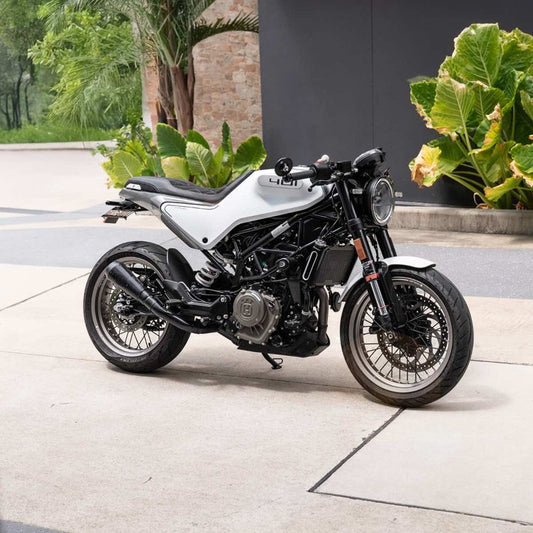 A Husqvarna Vitpilen 401 with a black Kelpi Shorty muffler. The bike also has a Kelpi custom seat trim and some Hindsight Mirrors