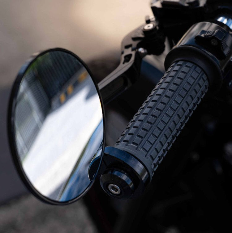 A close up of the Kelpi Rounder bar-end mirrors as well as a black Fitzroy grip