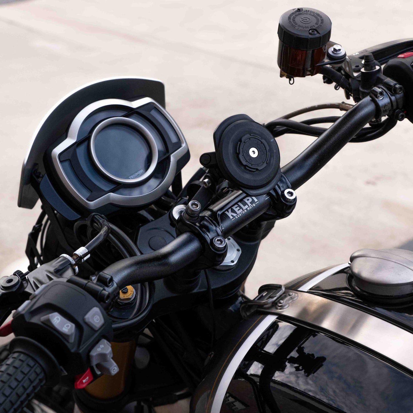 A triumph scrambler 1200 with a Kelpi Custom Moto Tracker 7050 Fat bars