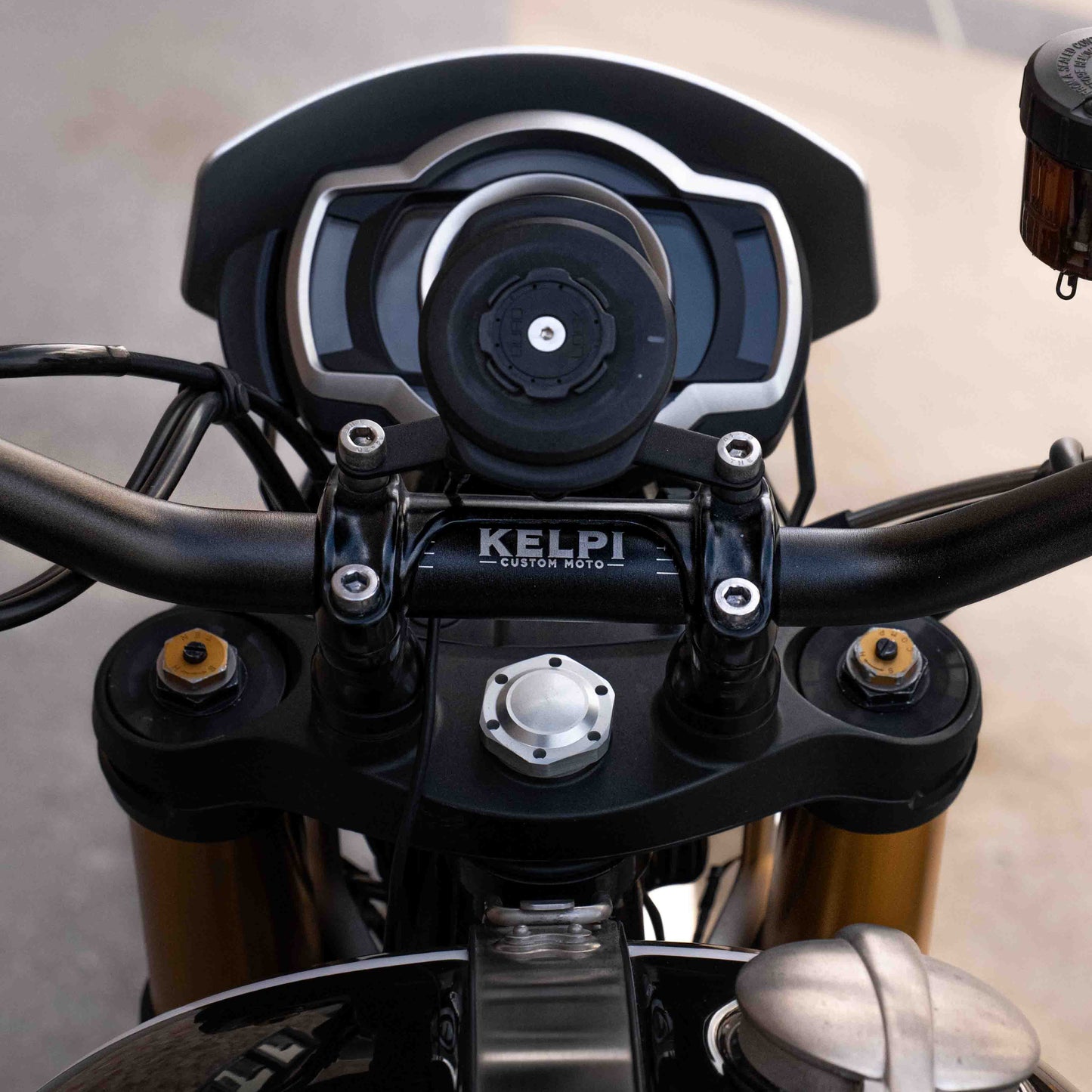A triumph scrambler 1200 with a Kelpi Custom Moto Tracker 7050 Fat bars