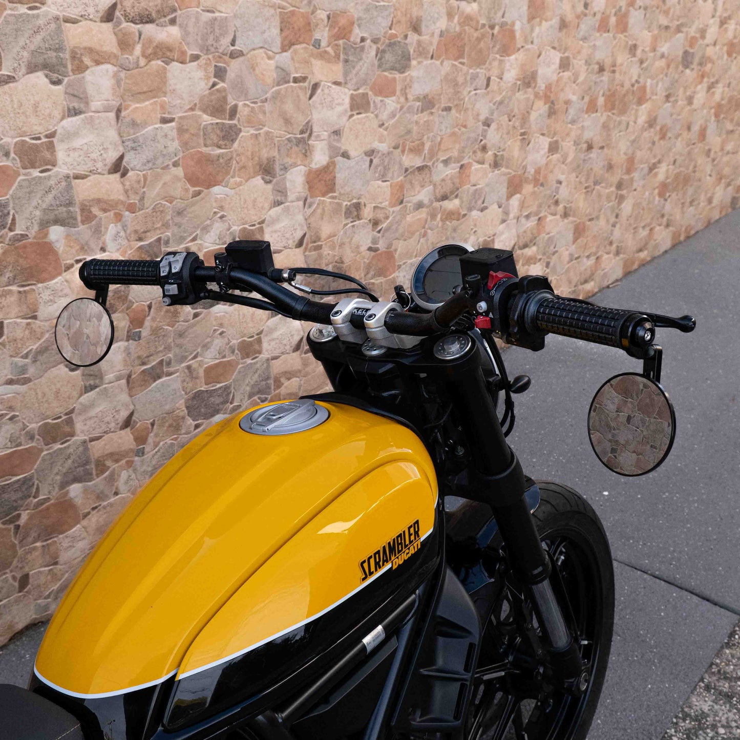 A Ducati Scrambler 800 with Kelpi Custom Moto Tracker 7050 Fatbars and Rounder mirrors