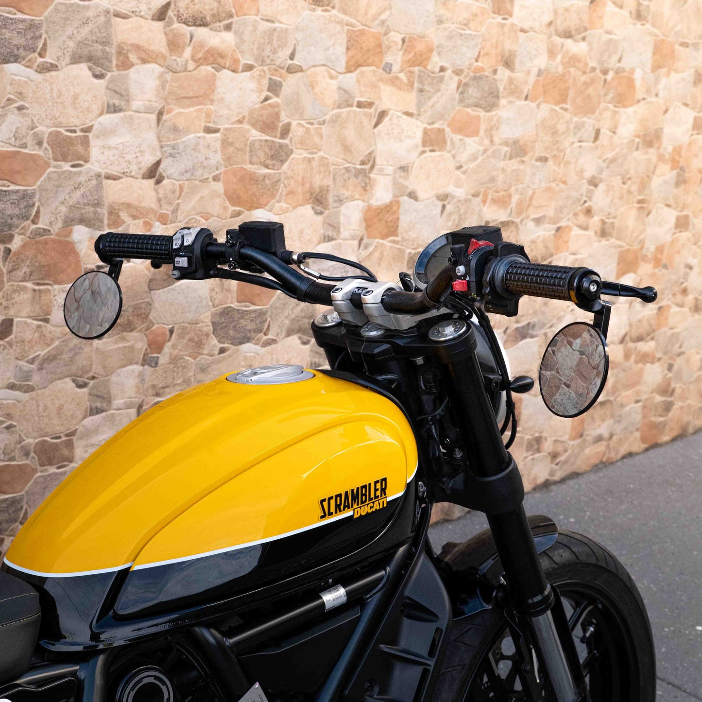 A Ducati Scrambler 800 with Kelpi Custom Moto Tracker 7050 Fatbars and Rounder mirrors