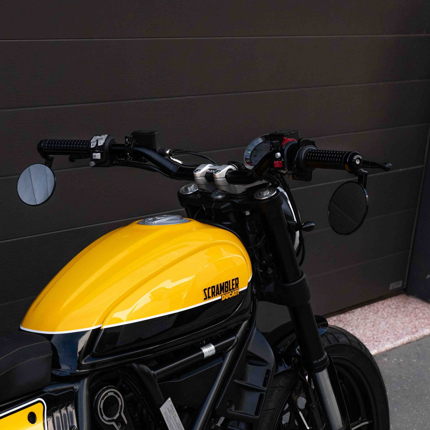 A Ducati Scrambler 800 with Kelpi Custom Moto Tracker 7050 Fatbars and Rounder mirrors