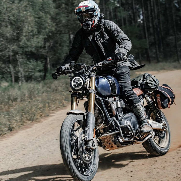 A man sitting in a Triumph Scrambler 1200 with a set of Kelpi Splitter bar end mirrors fitted