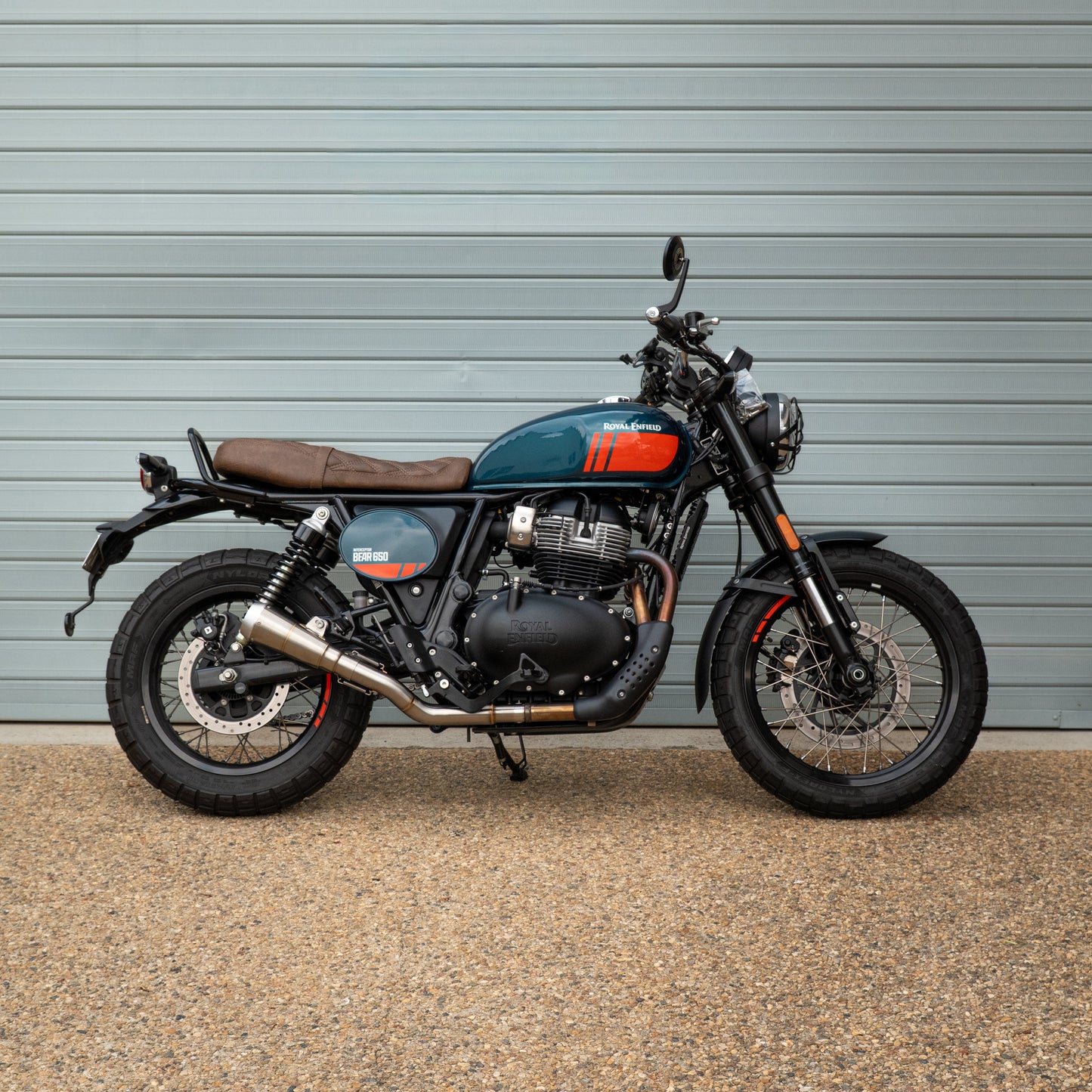 Motorcycle parked in front of a gray wall