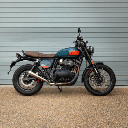 Motorcycle parked in front of a gray wall