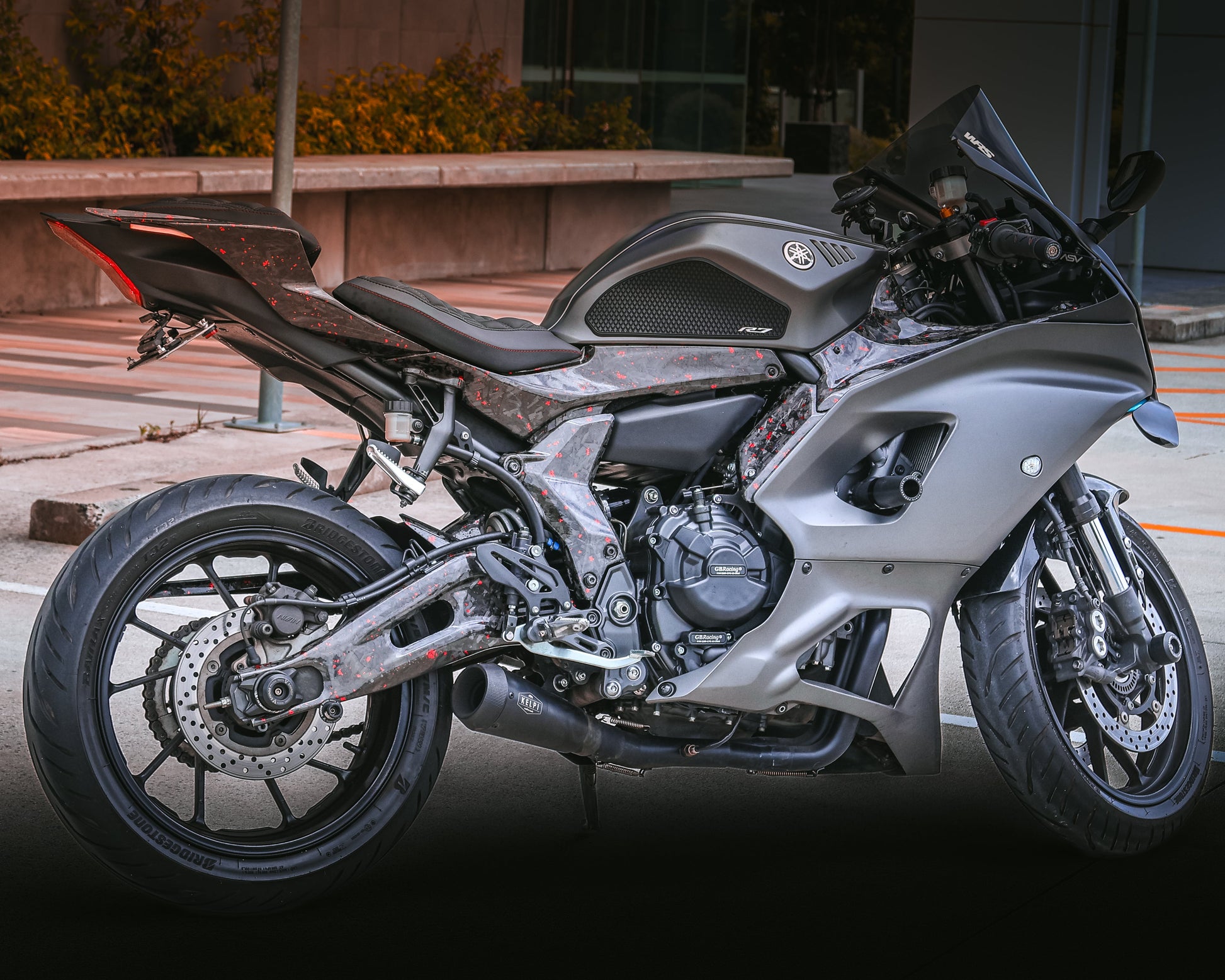 Gray motorcycle parked on a street with a blurred background