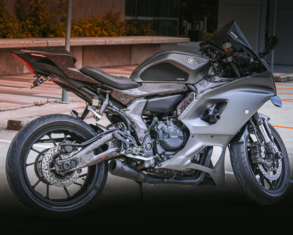 Gray motorcycle parked on a street with a blurred background