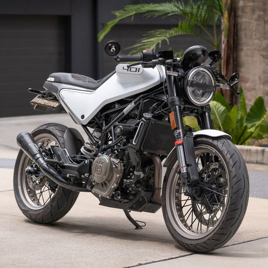 A Husqvarna Vitpilen 401 with a sit of Hindsight bar end mirrors. As well as this it has a custom seat trim and a Short slip on muffler. 