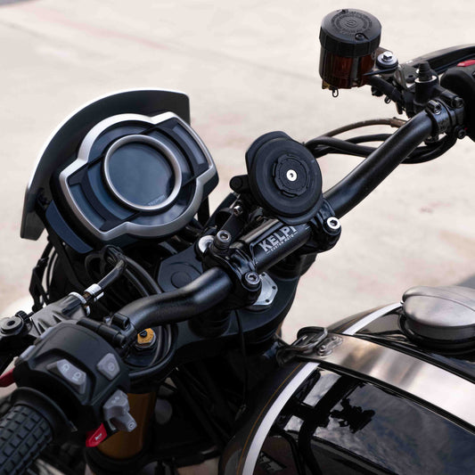 A triumph scrambler 1200 with a Kelpi Custom Moto Tracker 7050 Fat bars