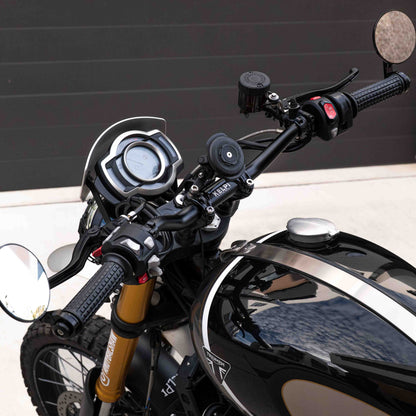 A triumph scrambler 1200 with a Kelpi Custom Moto Tracker 7050 Fat bars, rounder mirrors and fitzroy grips