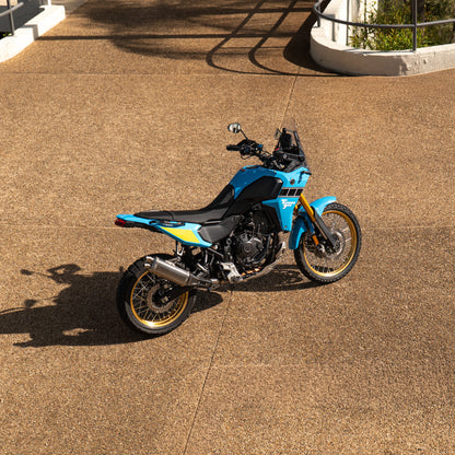 Blue motorcycle on a concrete surface with a blurred background