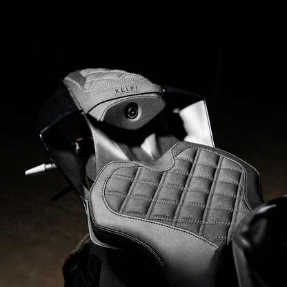 Close-up of a motorcycle seat with 'KELPI' branding on a dark background